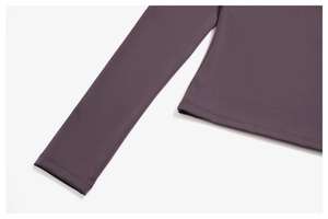 Detailed close-up of double-stitched cuffs on brushed purple yoga top fabric texture
