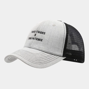 Detail of multi-row stitching on the brim of a two-tone mesh trucker snapback hat