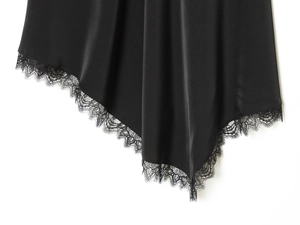 Macro shot of silky black satin fabric with intricate eyelash lace trim and refined texture