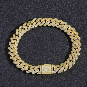 Detailed view of 10mm gold Cuban link bracelet with sparkling cubic zirconia on black background
