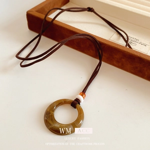 Retro amber resin circle pendant necklace on brown leather cord with jewelry box