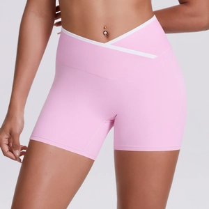 Detail of high waist V-cross yoga shorts with white piping in vibrant pink
