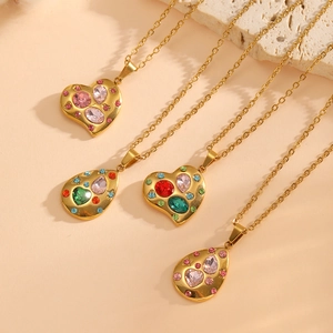 Detailed view of 18K gold plated heart and teardrop pendants with colorful gemstones