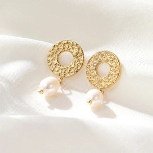 French vintage hammered gold hoop earrings with white pearls on a soft white silk background