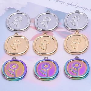 Detailed view of oval sunflower relief pendants in gold silver and rainbow finishes