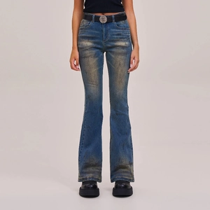 Detailed close-up of vintage washed flare jeans with artistic hand-painted distressed finish