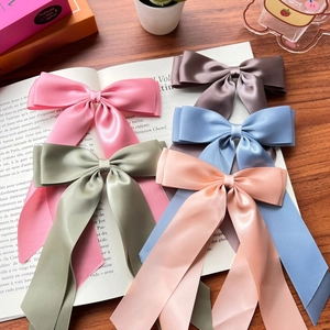 Elegant solid color satin double bow hair clips with long ribbons in multiple colors