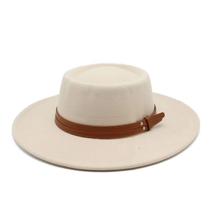 Close-up of beige wool felt flat top hat with brown leather strap and silver rivets