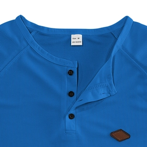 Close-up of royal blue waffle knit texture and Henley collar with size M label