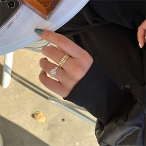 Close-up of stacked 925 sterling silver rings with pearl detail on a female finger