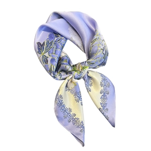 Pastel purple and yellow floral silk square scarf tied in a bow on white background