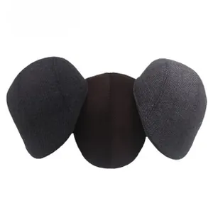 Detailed texture of knitted wool beret hats in dark grey, brown and charcoal colors