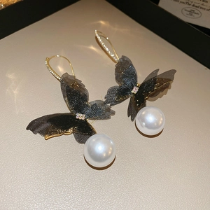 Detail of mesh butterfly earrings with pearl drops and sparkling crystal inlay