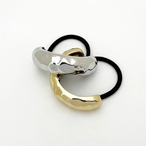 Detail of high-elasticity hair ties with textured gold and silver metal U-shaped ornaments