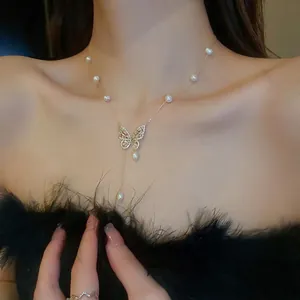 Elegant gold-plated butterfly necklace with freshwater pearls and tassel pendant detail