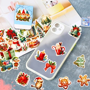 Macro shot of colorful Christmas stickers including snowman and reindeer on a phone case