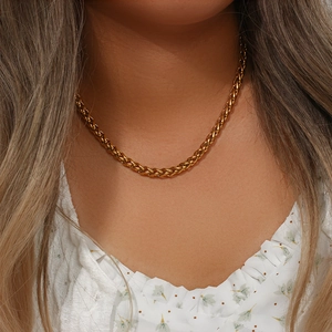 Close-up of golden 6mm woven basket chain necklace worn on neck for fashion detail