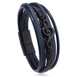 Close-up of blue layered leather bracelet with black musical treble clef metal detail