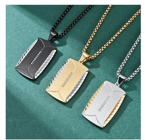 Three men's tire-tread dog tag pendants in black, gold, and silver on green velvet
