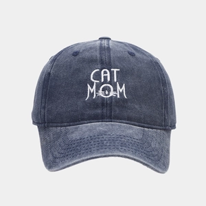 Detail of CAT MOM embroidery on a washed dark blue denim baseball cap for women