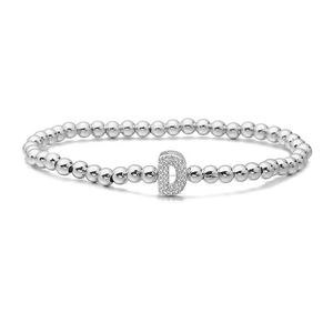 Macro detail of silver beaded bracelet featuring a micro-pave zircon letter D charm