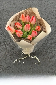 Detail of tulip bouquet wrapped in thickened honeycomb kraft paper with pearl ribbon decor