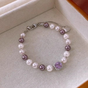 Detail of square purple zircon and pearl bracelet displayed in a premium jewelry box