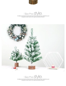 Close-up of mini snowy PVC Christmas trees with natural round wooden bases