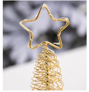 Close-up of golden wire star tree topper with warm LED lights and a spiral base