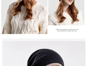 Detail of chunky cable-knit white sweater and two-tone black and beige slouchy beanie
