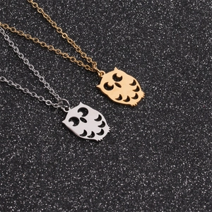 Polished gold and silver owl pendants with hollow design on black shimmer background