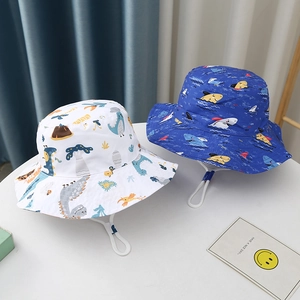 Close-up of kids sun hats with dinosaur and shark prints plus adjustable chin straps