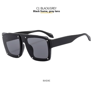 Side view of square oversized sunglasses featuring black frames and silver rivet details