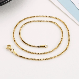 Detailed view of a gold-plated titanium steel box chain with a secure lobster clasp
