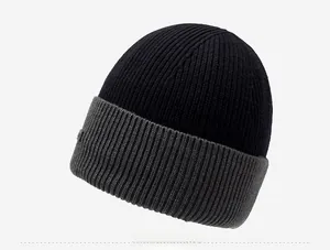 Close-up of dual-tone knit beanie with textured ribbing and decorative side label