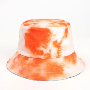 Close-up of orange and white tie-dye bucket hat showing fabric texture and stitching