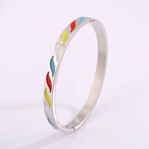 Detail of silver titanium steel bangle with colorful enamel flame patterns and clasp