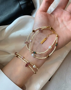 Detail view of double-layer beaded bracelet with freshwater pearls and gold plating