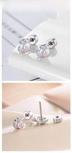 Macro detail of silver bowknot stud earrings featuring pink zircon and screw-back closure