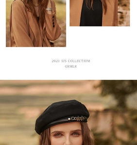 Detail of a black beret featuring a golden star chain accessory on a fashion model