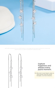 Detail of silver long tassel earrings with star charms and delicate chain design