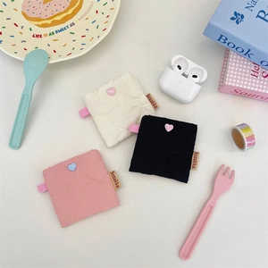 Quilted heart headphone pouch shown in pink, white, and black with cute decorative buttons