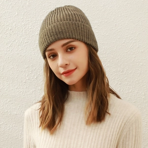 Olive green vertical knit beanie for winter made of soft wool displayed on a model