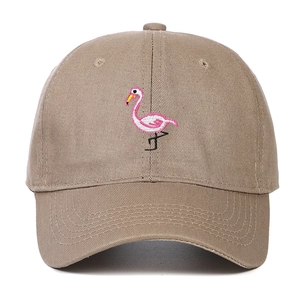 Close-up of pink flamingo embroidery on khaki cotton canvas baseball cap front