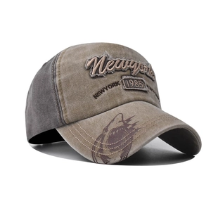 Detail of vintage baseball cap featuring shark graffiti print and distressed frayed edge