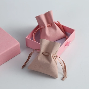 Close-up of soft microfiber drawstring jewelry pouches with elegant texture and matte finish