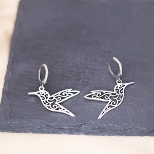 Sleek stainless steel hummingbird hoop earrings with intricate hollow-out floral details
