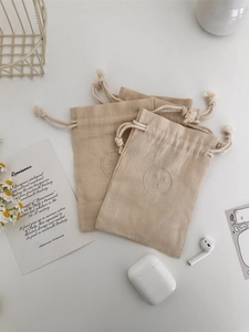 Three-piece linen drawstring bags with embroidered smile face for small accessories