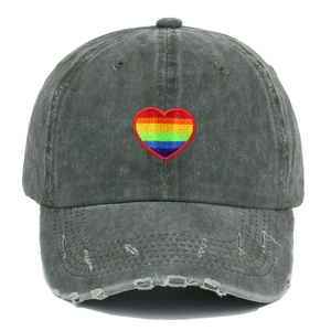 Distressed dark grey baseball cap with rainbow heart embroidery and vintage torn details
