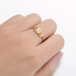 Detail of adjustable golden stainless steel ring featuring gothic 1999 cutout design